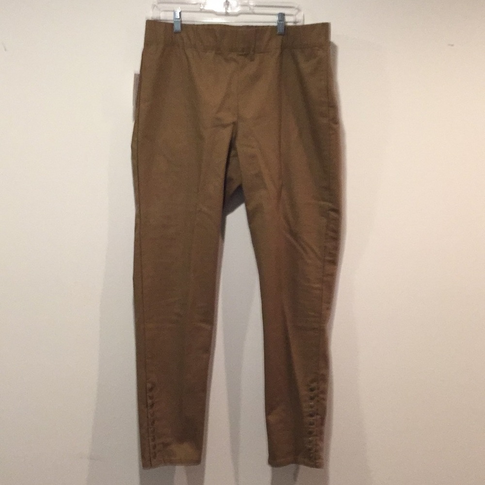Tan skinny leg pants with gold snap trim